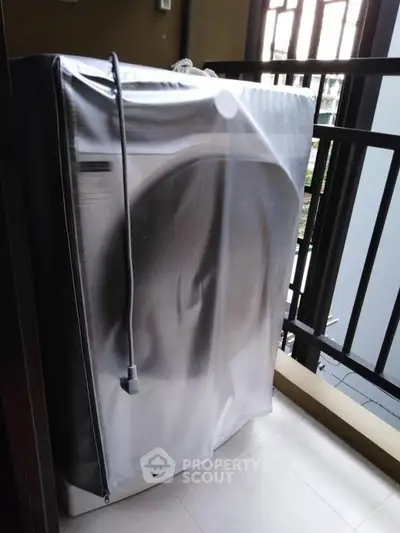 Modern washing machine on a balcony in a contemporary apartment setting.