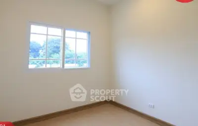 Bright empty room with large window and wooden floor