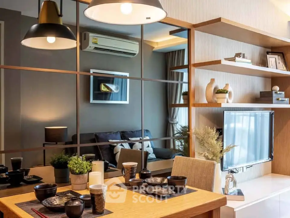Modern living room with stylish decor and dining area, featuring elegant lighting and contemporary furniture.