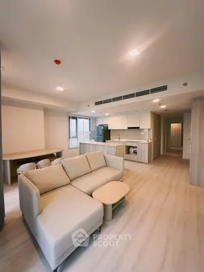 Spacious modern living room with open kitchen layout and stylish furniture