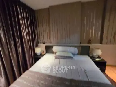 Cozy bedroom with elegant decor and soft lighting, featuring a comfortable bed and stylish bedside lamps.