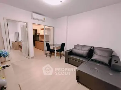 Modern living room with sleek furniture and open kitchen layout