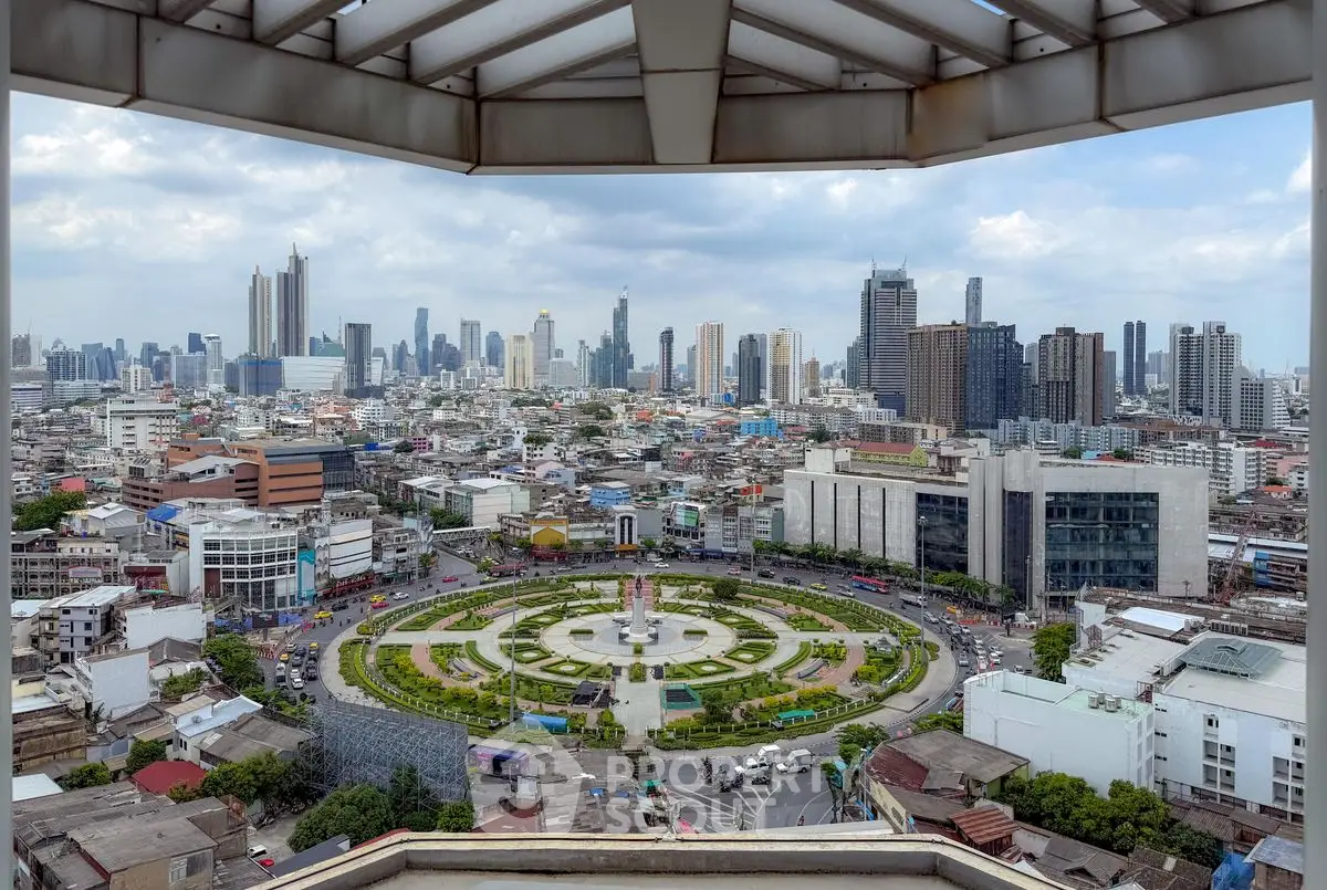 Stunning cityscape view from a high-rise balcony overlooking a vibrant urban landscape.