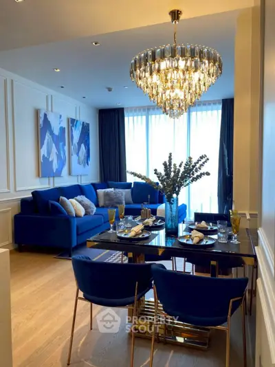 Luxurious living room with elegant chandelier and stylish blue decor