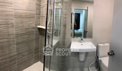 Modern bathroom with sleek shower and elegant fixtures in contemporary design.