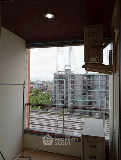 Spacious balcony with city view in modern apartment building.