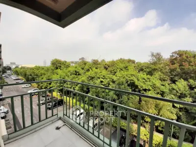 Spacious balcony with lush green view and ample parking space