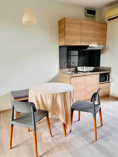 Modern kitchen with dining area featuring sleek cabinetry and contemporary furniture.