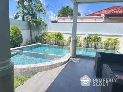 Luxurious private pool with modern patio in tropical garden setting