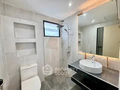 Modern bathroom with sleek fixtures and large mirror