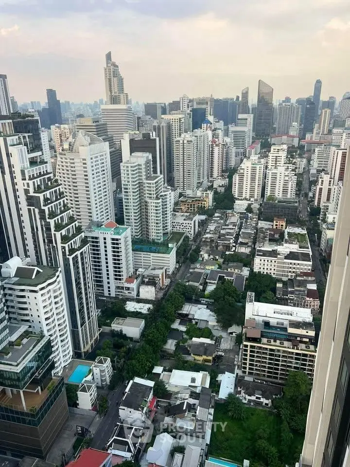 Stunning cityscape view from a high-rise building, showcasing urban skyline and architectural diversity.