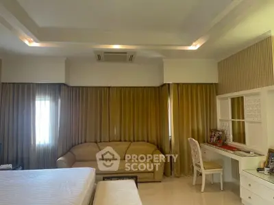 Luxurious bedroom with elegant decor and cozy seating area, perfect for relaxation and comfort.