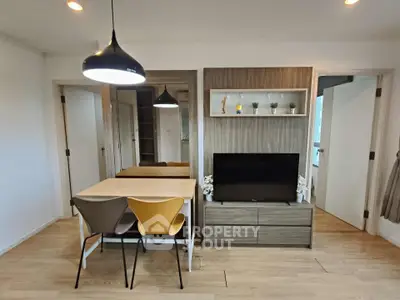 Modern living room with stylish dining area and sleek wooden furniture