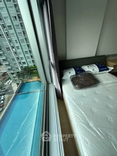 Modern bedroom with pool view in high-rise apartment