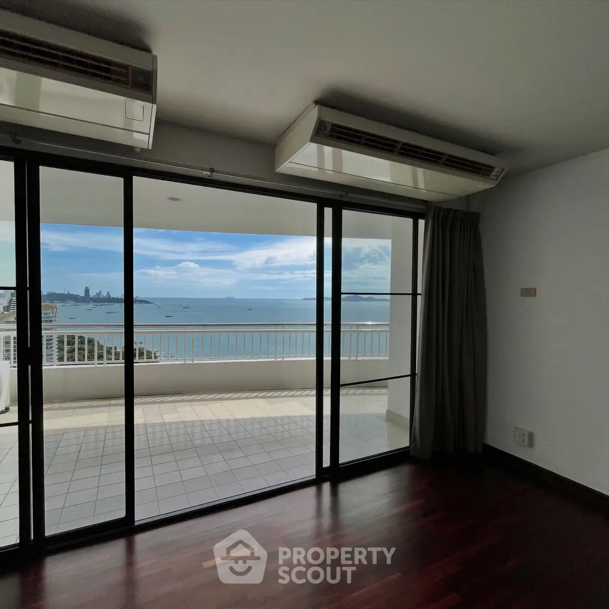 Spacious living room with stunning ocean view and large balcony access.