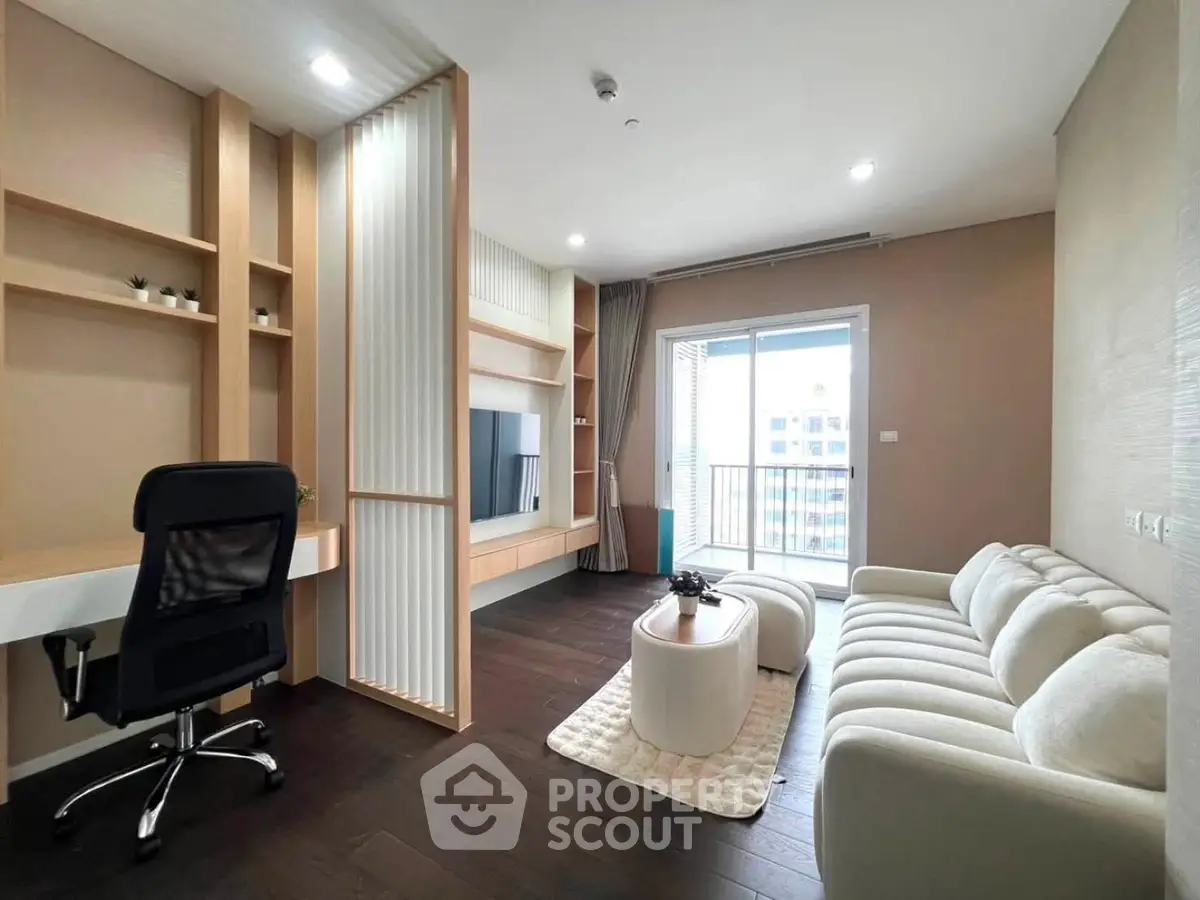 Modern living room with sleek furniture and balcony view in a stylish apartment.