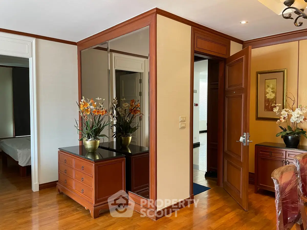 Elegant interior with wooden furniture and mirrored closet in a stylish apartment
