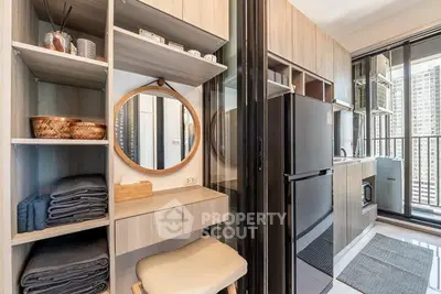 Modern kitchen with sleek appliances and stylish storage solutions in a high-rise apartment.