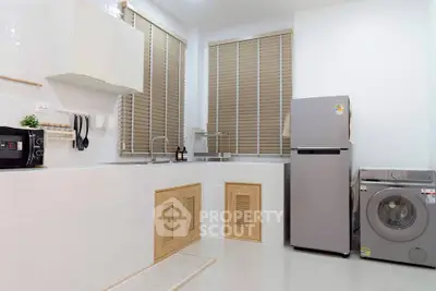 Modern kitchen with sleek appliances and ample natural light