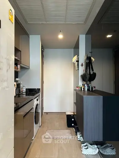 Modern kitchen with sleek cabinetry and built-in appliances in a compact layout.