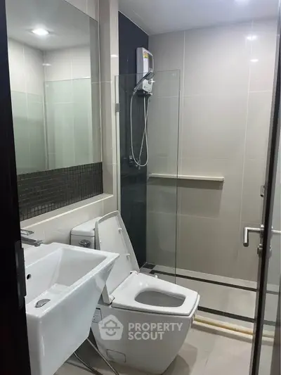 Modern bathroom with glass shower and sleek fixtures