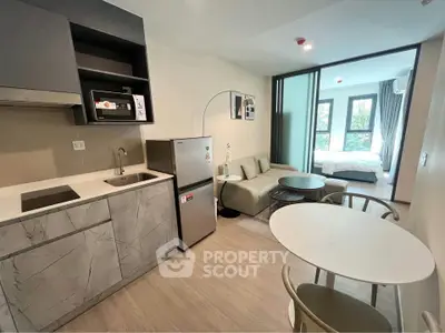 Modern open-plan kitchen and living area with sleek design and natural light