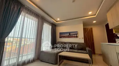 Modern living room with large windows and stylish furniture in a cozy apartment.