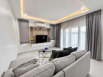 Modern living room with stylish decor and large windows