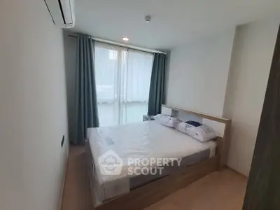 Modern bedroom with natural light and minimalist design, featuring a comfortable bed and stylish curtains.