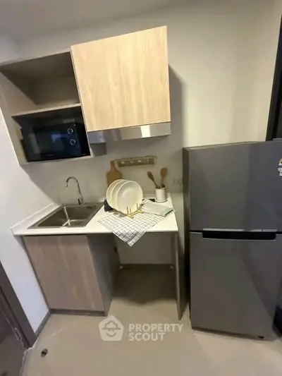 Modern compact kitchen with sleek cabinetry and stainless steel appliances