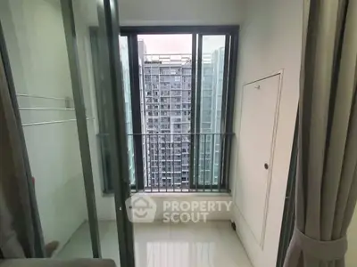 Modern apartment balcony with city view and sliding glass doors