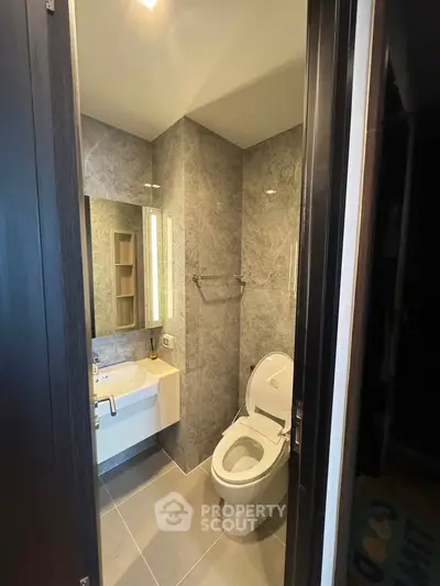 Modern bathroom with sleek design and elegant fixtures in a contemporary apartment.