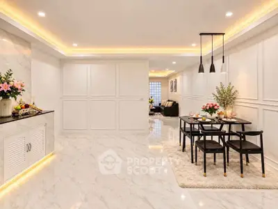 Luxurious open-plan dining and living area with elegant lighting and marble flooring