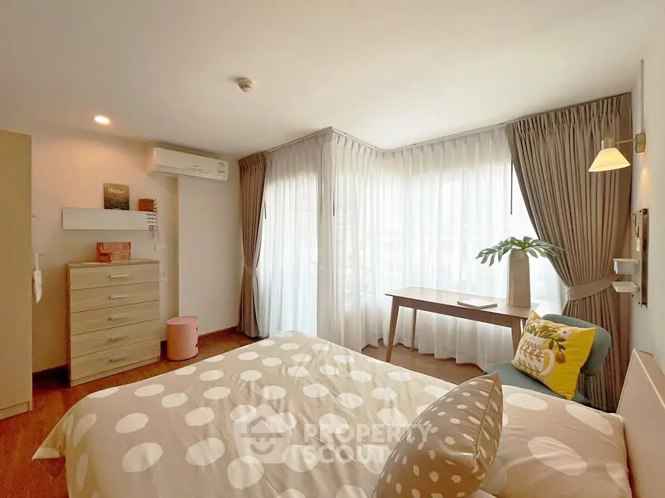 Bright and cozy bedroom with large windows and modern decor