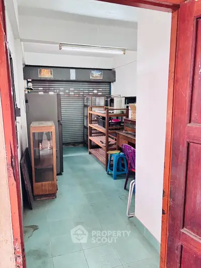 Cozy storage room with shelving and appliances, ideal for organizing and maximizing space efficiency.