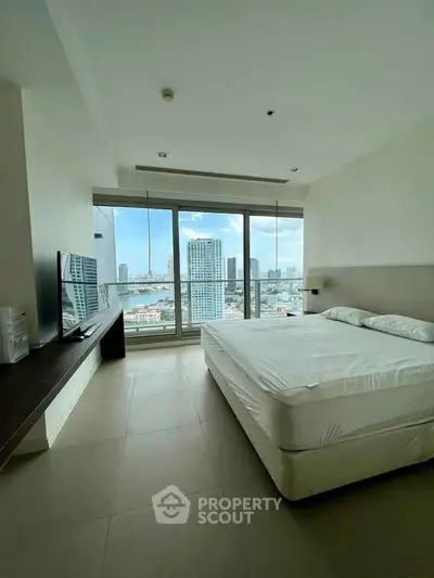 Spacious bedroom with stunning city view and modern furnishings