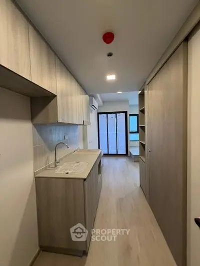 Modern kitchen with sleek cabinetry and open layout in contemporary apartment