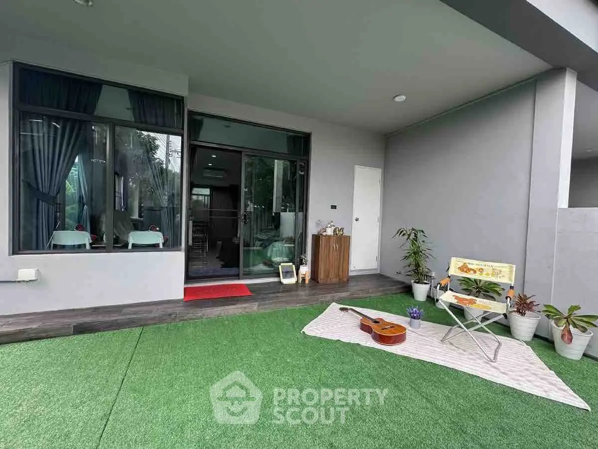 Charming garden patio with cozy seating and lush greenery, perfect for relaxation and entertainment.