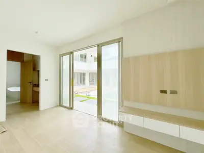 Modern minimalist interior with large windows and wooden flooring