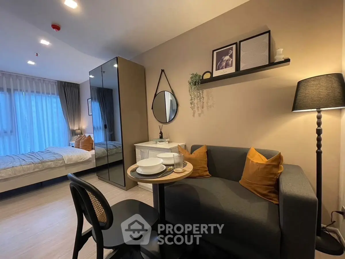 Modern studio apartment with cozy living area and stylish decor