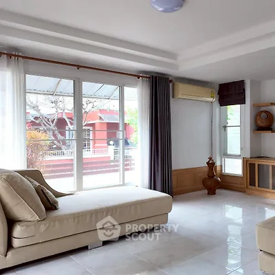 Spacious living room with large windows and modern decor