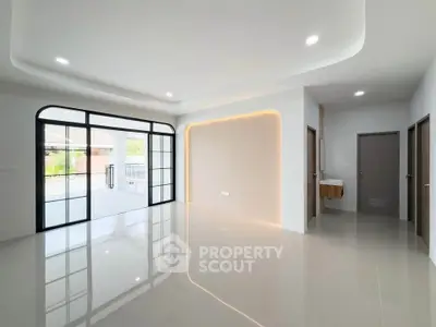 Spacious modern living room with sleek design and large windows for natural light.