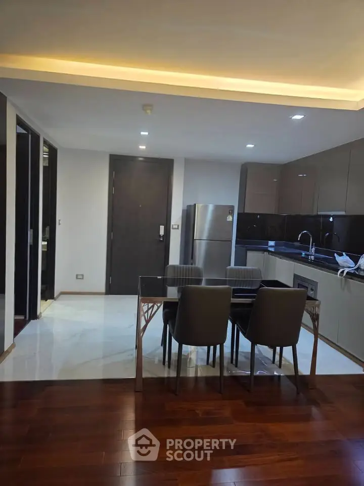 Modern kitchen with sleek cabinetry and dining area in luxury apartment
