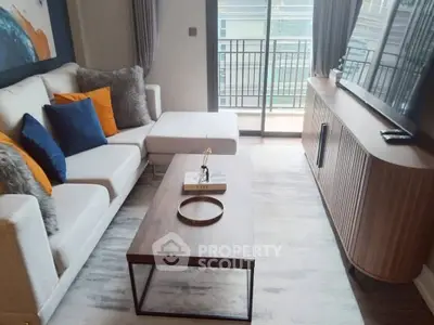 Stylish living room with modern furniture and balcony view