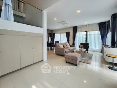 Spacious modern living room with elegant decor and ample natural light.