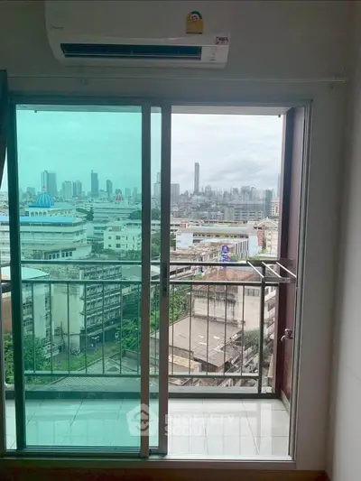 High-rise apartment balcony with panoramic city skyline view.