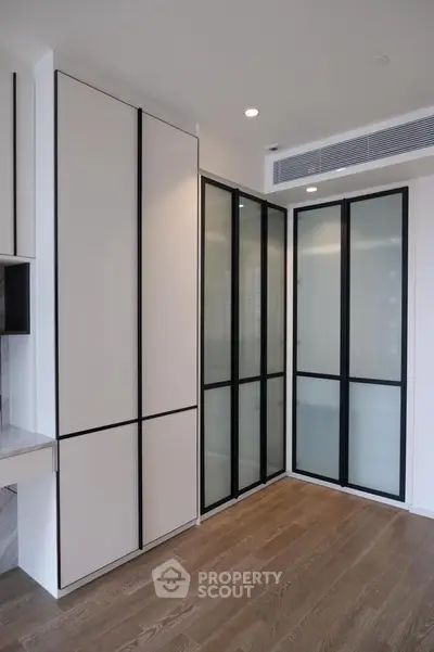 Modern interior with sleek storage solutions and elegant wooden flooring