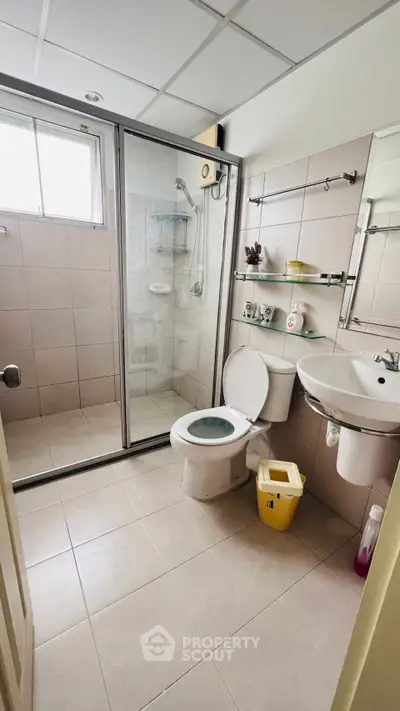 Modern bathroom with glass shower and sleek fixtures in a contemporary home.