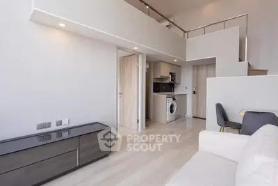 Modern loft apartment with open layout, featuring a sleek kitchen and stylish living area.