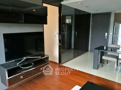 Modern living room with sleek furniture and wooden flooring in a stylish apartment.